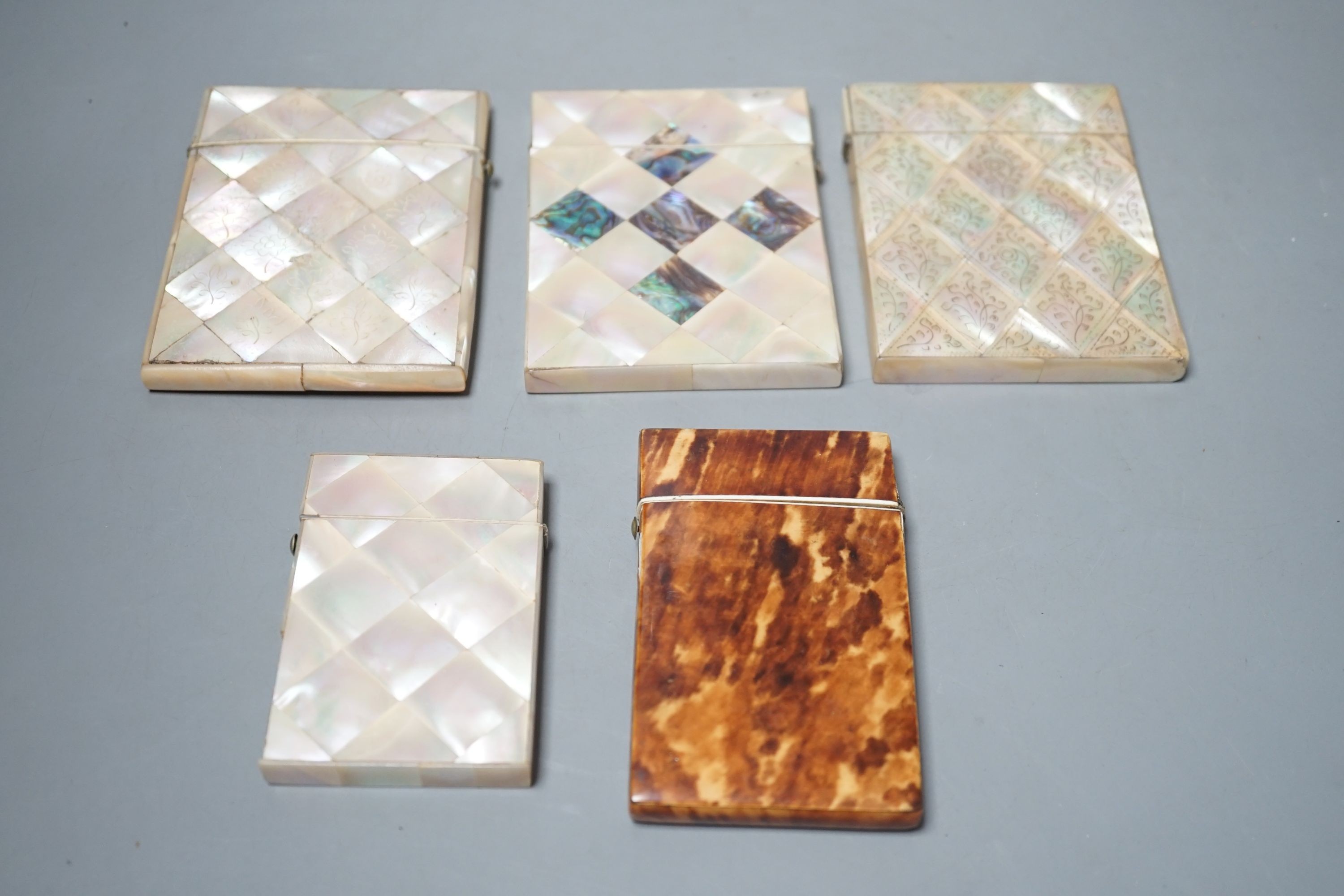 A selection of four mother of pearl card cases, together with another tortoiseshell card case inlaid with bone (5)